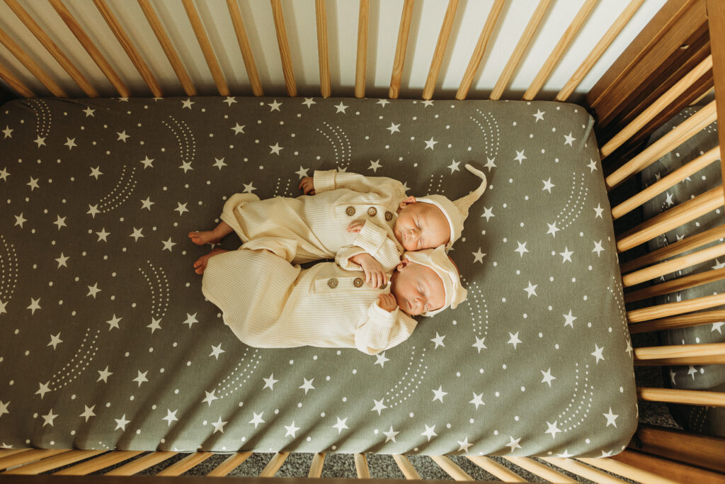 twin newborns in crib in nursery iowa city iowa