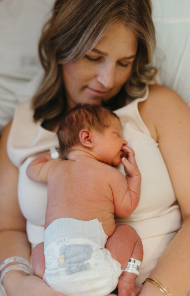 Mom cuddling newborn baby during fresh 48 photos