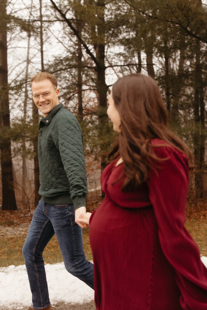 a couple taking maternity photos at Lake Macbride State Park in Solon, IA