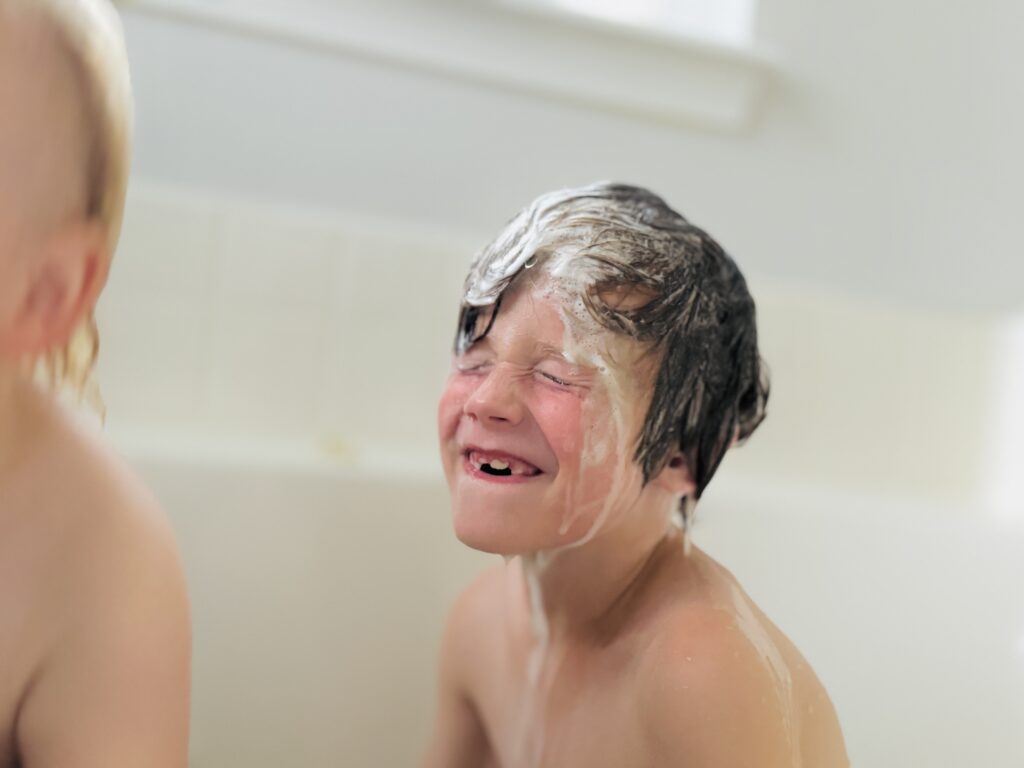 kid having fun taking bath photo