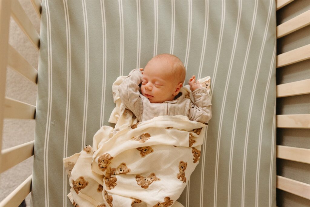 newborn baby sleeping in crib iowa city