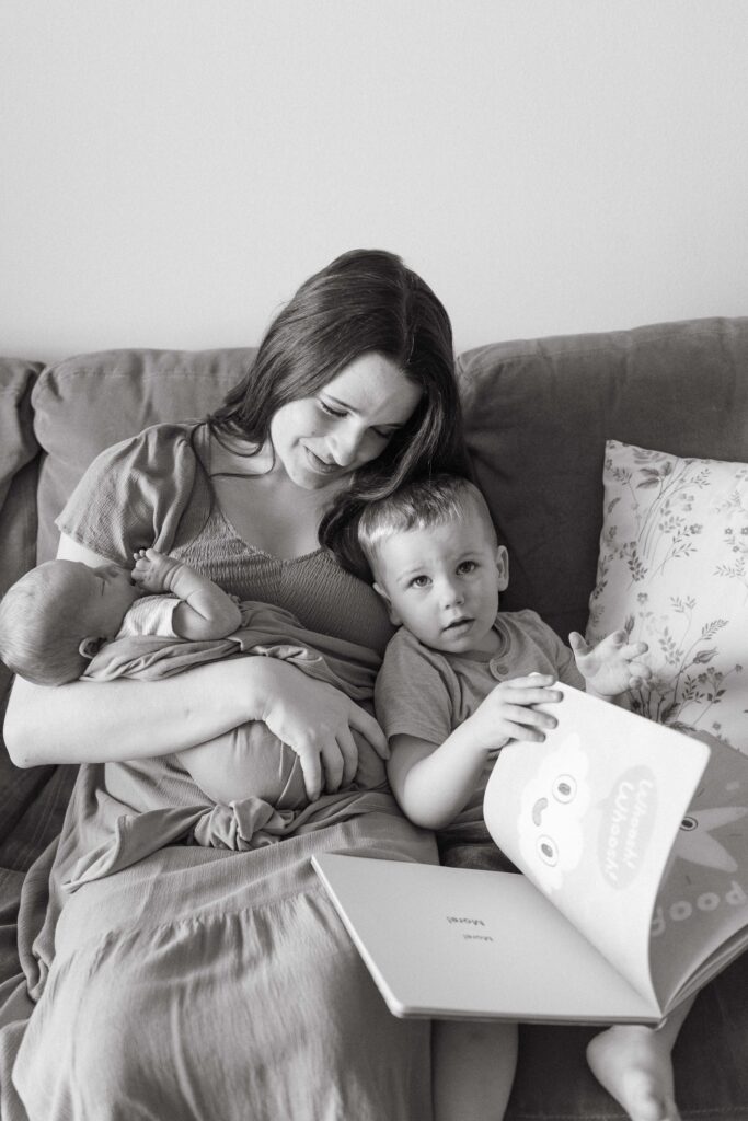 sibling and mom with newborn baby during newborn session iowa city