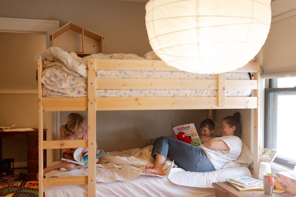 family reading in bed, family photos iowa city