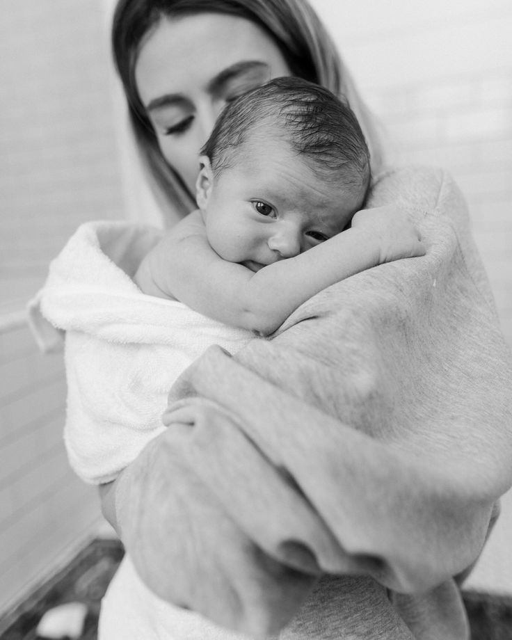 mom with newborn baby bath