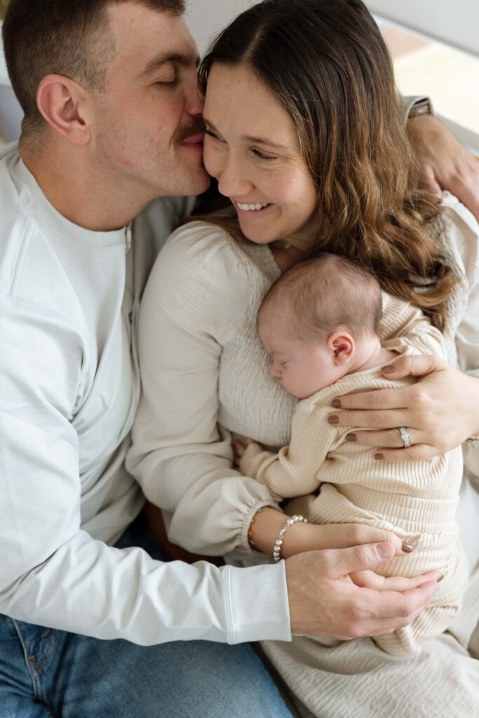 parents with newborn baby during newborn photography session in iowa city iowa