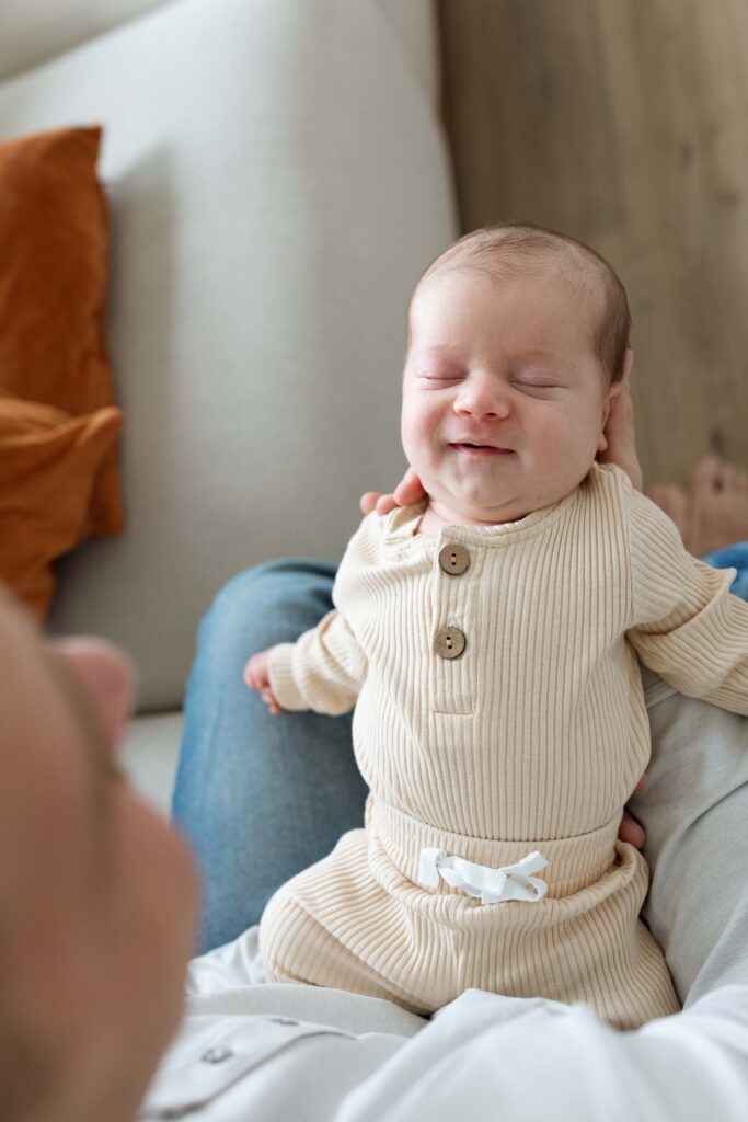 dad with newborn baby at home in iowa city iowa
