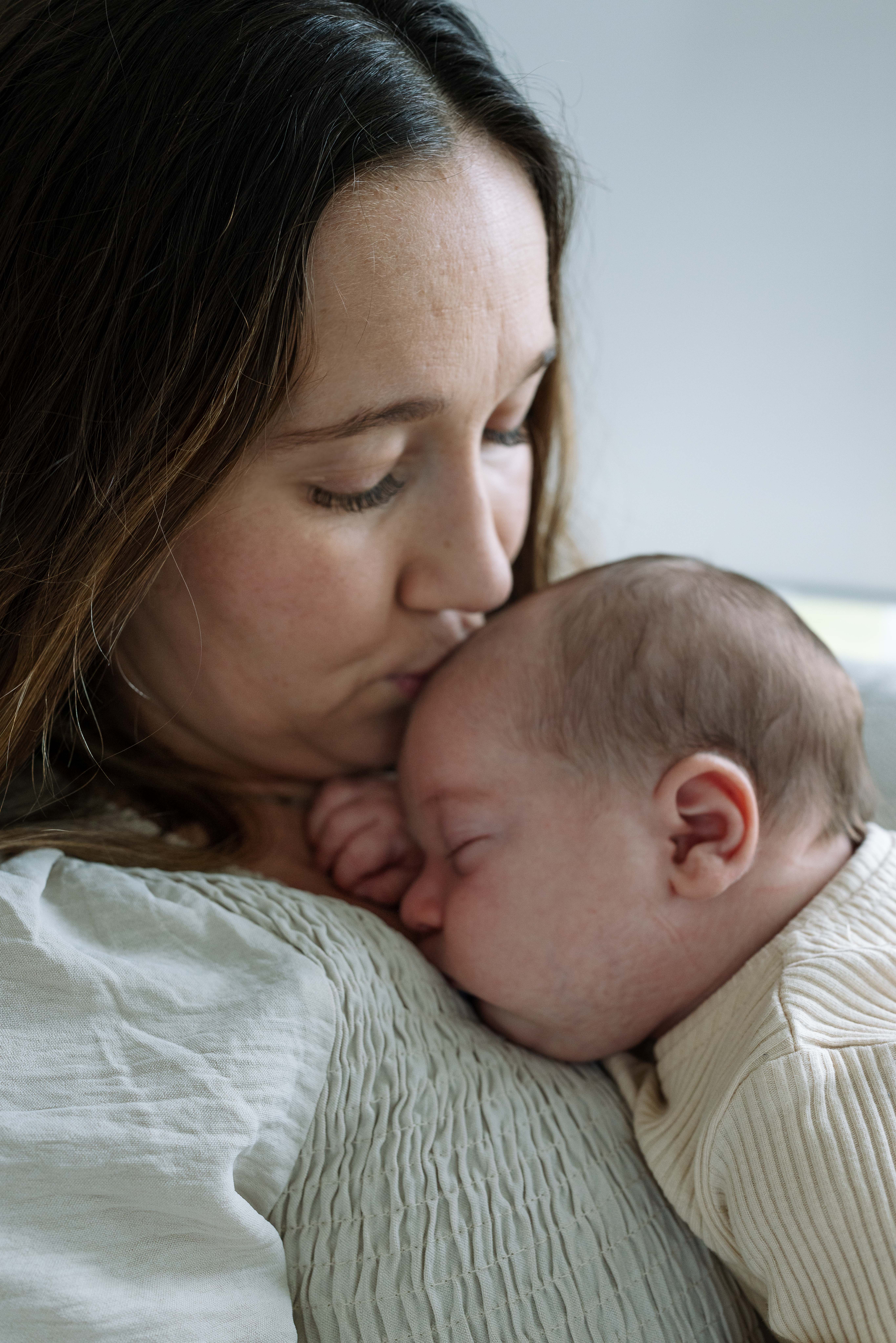 mom with newborn baby during newborn photography session iowa city iowa