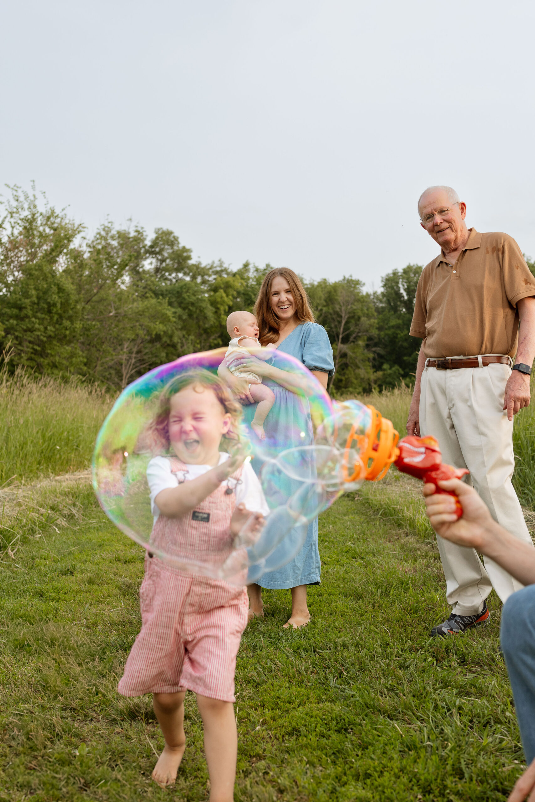 kid playing with family during a family photo session cedar rapids iowa
