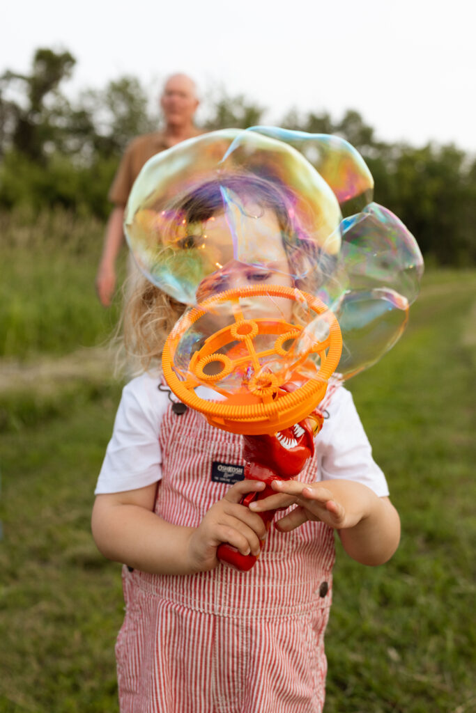 little boy playing with bubbles in cedar rapids iowa