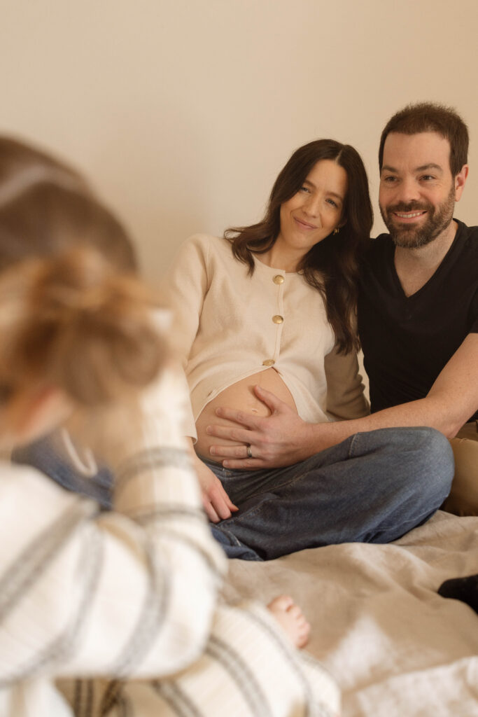 daughter taking parents picture during maternity photos iowa city